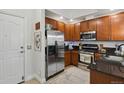 Functional kitchen showcasing stainless steel refrigerator, microwave, and gas range at 1700 N Emerson St # 305, Denver, CO 80218