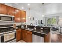 Well-appointed kitchen featuring stainless steel appliances and a seamless view into the living space at 1700 N Emerson St # 305, Denver, CO 80218