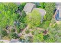 Aerial view of a beautifully landscaped backyard with a garden and mature trees, perfect for outdoor relaxation at 3014 E Fremont Dr, Centennial, CO 80122