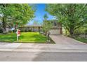 Charming home with a well-manicured lawn, mature trees, and a two-car garage in a desirable neighborhood at 3014 E Fremont Dr, Centennial, CO 80122