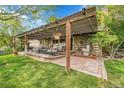 Inviting outdoor patio with comfortable seating, pergola, and a serene water fountain, perfect for entertaining at 3014 E Fremont Dr, Centennial, CO 80122