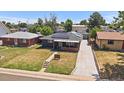 Aerial view of a charming single story home, showcasing the roof's solar panels and long driveway at 1742 S Alcott St, Denver, CO 80219