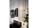Close up of modern kitchen, featuring stainless steel microwave and range with gray cabinets and white subway tile backsplash at 1050 N Corona St # 206, Denver, CO 80218