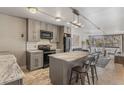 Open kitchen boasts marble island, stainless appliances, and seamless flow to dining area at 1050 N Corona St # 206, Denver, CO 80218