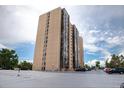 High-rise building with sleek design, parking and verdant landscaping at 7865 E Mississippi Ave # 1006, Denver, CO 80247