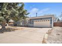 The property features a two-car garage and a spacious driveway for ample parking at 11744 W 71St Pl, Arvada, CO 80004