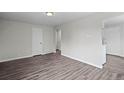 Bright living room featuring wood-look floors, fresh paint and multiple doorways providing great circulation at 4787 Carr St, Wheat Ridge, CO 80033