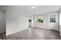 Inviting living room with wood-look floors, fresh paint, and large window overlooking the front yard at 4787 Carr St, Wheat Ridge, CO 80033