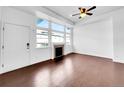 Bright living room featuring large windows and hardwood floors at 12032 Leyden St, Brighton, CO 80602