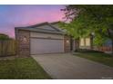 Single-story home with brick and siding, featuring a two-car garage and front lawn at 2209 S Flanders St, Aurora, CO 80013