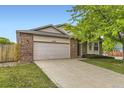 Inviting single-story home with a brick facade, two-car garage, and a meticulously kept lawn at 2209 S Flanders St, Aurora, CO 80013