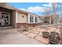 Inviting front patio with stone pavers and ample seating, perfect for outdoor relaxation and entertaining at 16084 E Lehigh Cir, Aurora, CO 80013