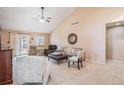 Bright living area featuring vaulted ceilings, neutral tones, and a sliding door to the backyard at 16084 E Lehigh Cir, Aurora, CO 80013
