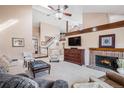 Spacious living room with vaulted ceilings, brick fireplace, and large windows for abundant natural light at 16084 E Lehigh Cir, Aurora, CO 80013
