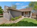 Charming home featuring an attached garage and cozy front patio area with seating at 5566 S Zinnia St, Littleton, CO 80127