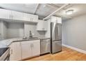 Efficient kitchen featuring stainless steel appliances, granite counters, and white cabinets at 2607 E 14Th Ave, Denver, CO 80206