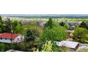 Residential neighborhood with mature trees and houses with varying roof styles and colors at 962 S Beech St, Lakewood, CO 80228