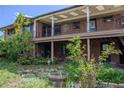 Two-story brick house with a balcony, a patio, and a partially shaded area at 962 S Beech St, Lakewood, CO 80228