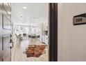 Bright, open-concept living space with light wood floors, modern furnishings, and plenty of natural light at 2851 W 52Nd Ave # 208, Denver, CO 80221