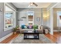 Cozy living room featuring hardwood floors, updated paint, and abundant natural light at 3946 Perry St, Denver, CO 80212