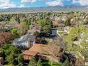 Beautiful aerial view showcases a neighborhood with lush greenery and mountains in the distance at 2250 S Zang Ct, Lakewood, CO 80228