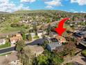 Listing home shown in an aerial view surrounded by greenery and other houses at 2250 S Zang Ct, Lakewood, CO 80228