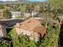 Aerial view features the backyard with a brick chimney and a pergola with patio furniture at 2250 S Zang Ct, Lakewood, CO 80228