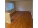 Bright living room featuring beautiful hardwood floors, a large window providing natural light, and neutral wall colors at 2995 S Whiting Way, Denver, CO 80231