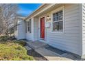 The front entrance of this home features a bright red door and a well-lit entryway at 2370 S Ogden St, Denver, CO 80210