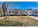 Charming home featuring a well-maintained front yard with mature trees and a quaint detached garage at 2370 S Ogden St, Denver, CO 80210