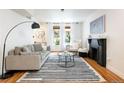Bright living room features a fireplace, modern decor, hardwood flooring, and lots of natural light at 1415 E 16Th Ave # 1/2, Denver, CO 80218