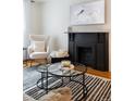 Elegant living room with a fireplace and contemporary glass coffee tables at 1415 E 16Th Ave # 1/2, Denver, CO 80218