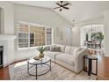 Bright living room with large windows, vaulted ceiling, and hardwood floors at 12335 E 2Nd Dr, Aurora, CO 80011