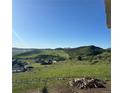 Scenic view of rolling hills and a neighborhood from the backyard of a home at 5489 Country Club Dr, Larkspur, CO 80118