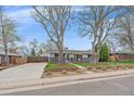 Beautiful single-story home with well-manicured lawn, brick landscaping, and inviting entrance at 6482 S Cedar St, Littleton, CO 80120