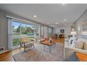 Bright and spacious living room featuring large windows and hardwood floors at 6482 S Cedar St, Littleton, CO 80120