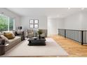 Bright living room with modern furnishings, neutral colors, and hardwood floors at 179 N Prairie Falcon Pkwy, Brighton, CO 80601