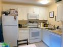 Efficient kitchen features white cabinets, appliances, and ample counter space at 3161 Madison Ave # R313, Boulder, CO 80303