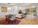Open-concept living room with a fireplace, high ceilings, a dining area, and large sliding glass doors at 2938 Kalmia Ave # 6, Boulder, CO 80301