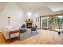 Bright living room featuring a cozy fireplace, vaulted ceiling, and a sliding glass door with mountain views at 2938 Kalmia Ave # 6, Boulder, CO 80301