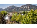 Scenic mountain view from a home surrounded by lush greenery and mature trees in a peaceful setting at 2938 Kalmia Ave # 6, Boulder, CO 80301