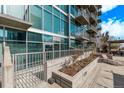 Modern building exterior featuring floor-to-ceiling windows, steel railings, and private patios at 1700 Bassett St # 820, Denver, CO 80202