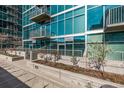 Contemporary building featuring reflective glass, metal balconies, and sidewalk landscaping at 1700 Bassett St # 820, Denver, CO 80202