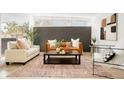 Stylish living room with a neutral palette and a chic area rug at 6087 S Elizabeth Way, Centennial, CO 80121