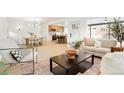 Bright open-concept living room with modern decor flowing to the kitchen at 6087 S Elizabeth Way, Centennial, CO 80121