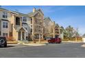 Multi-story condominium complex featuring stone accents, balconies, and well-maintained landscaping at 18989 E Warren Dr # G303, Aurora, CO 80013