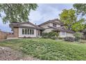 Charming two-story home boasts a beautiful lawn and complemented by lush trees in the background at 10397 Yates Ct, Westminster, CO 80031