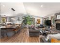 Open concept living room features a modern gray kitchen with large island and wood floors at 400 Upper Forest Rd, Idaho Springs, CO 80452