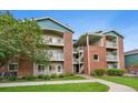 Attractive condo building features brick accents and multiple balconies at 2705 S Danube Way # 103, Aurora, CO 80013