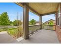 Inviting covered front porch with decorative pillars, offering a relaxing outdoor space at 4732 S Coolidge St, Aurora, CO 80016